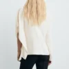 Bluse mit hohem Kragen und asymmetrischen Ärmeln Bluse mit hohem Kragen und asymmetrischen Ärmeln