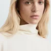 Bluse mit hohem Kragen und asymmetrischen Ärmeln Bluse mit hohem Kragen und asymmetrischen Ärmeln