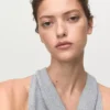 Lurex-Strickoberteil mit drapiertem Ausschnitt Lurex-Strickoberteil mit drapiertem Ausschnitt